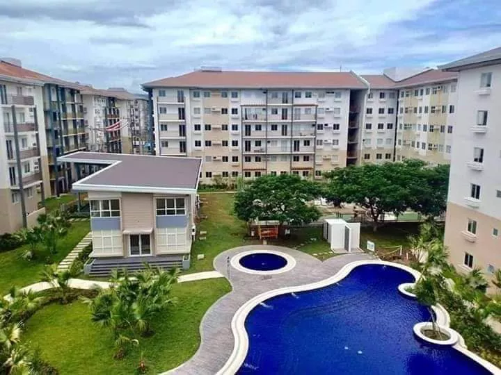 Amaia Steps NUVALI — pool, clubhouse, and residential buildings